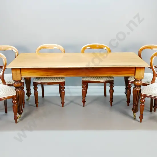vintage dining table w/6 matching carved balloon back chairs, all with fluted legs, table on brass casters. Top