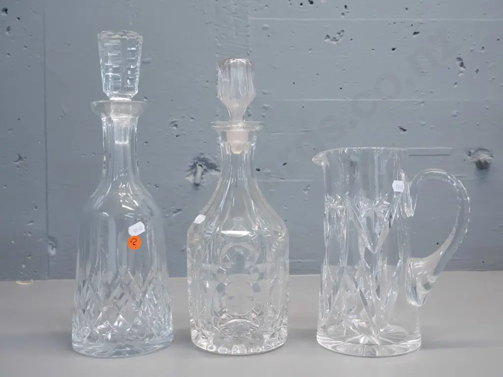 3 cut crystal items - 2 stoppered decanters and a large jug, no maker's marks. Larger decanter is H-330 Image 1++