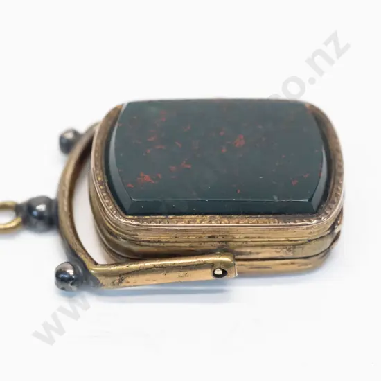 locket with dark stone on swing hinge no chain
