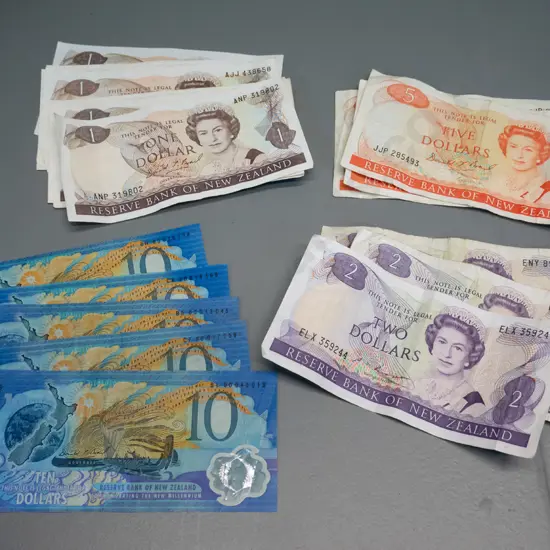 New Zealand bank notes - 5 Millennium $10 notes and assorted $1, $2, and $5 - all in used condition