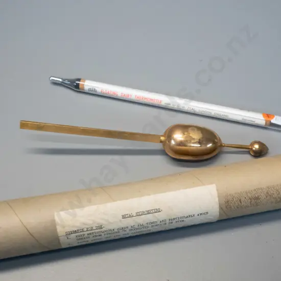 "Zeal" English metal Hydrometer and a glass cased floating dairy thermometer L-290