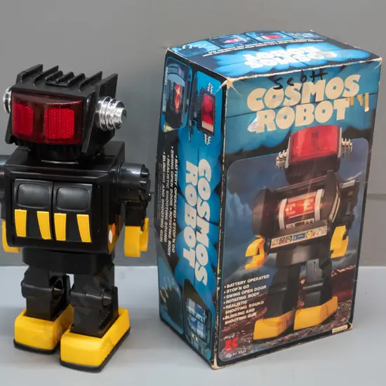 Cosmos battery powered toy robot in original box - untested but battery compartment is clean. H-310 W-180