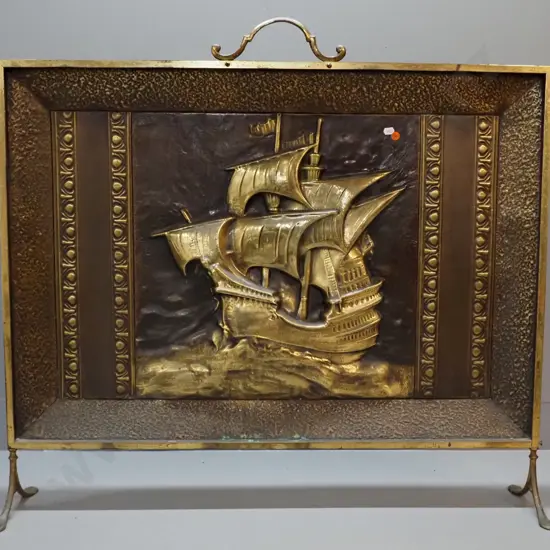 deco beaten brass galleon motif large fire screen with scroll handles and feet, some verdigris. Marked Myttons, Made in