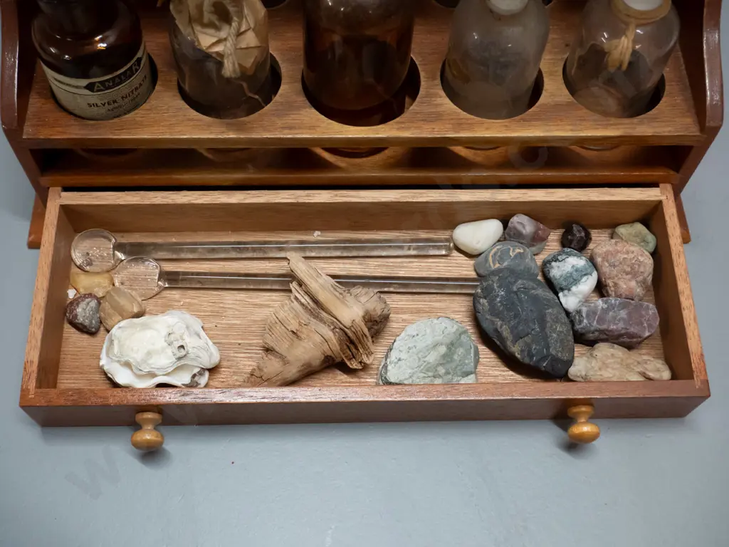 vintage wooden chemist's stand with assorted bottles, test tubes, and mineral samples in drawer Image 1++