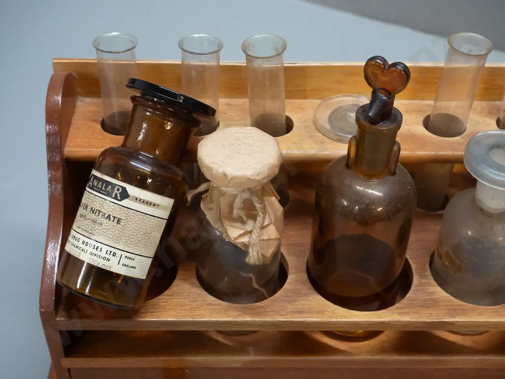 vintage wooden chemist's stand with assorted bottles, test tubes, and mineral samples in drawer Image 1++