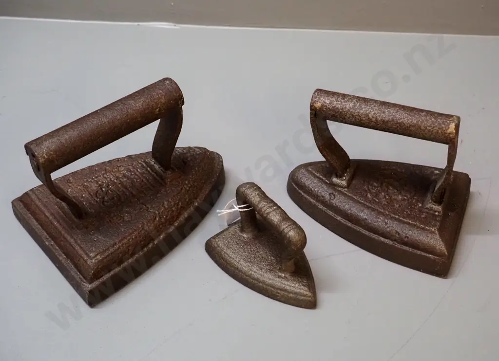 3 cast iron items - 2 sad irons and a collar & cuff iron, no maker's mark - unreadable marks, larger is Image 1++