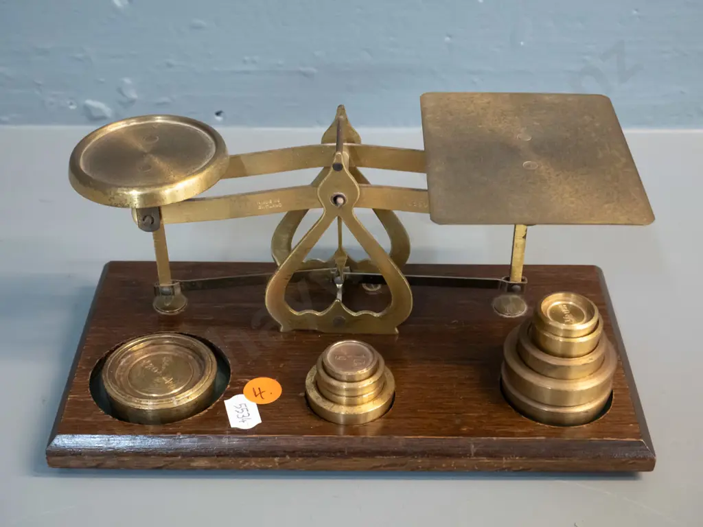 small set of brass balance scales on wooden base, with 10 weights - marked Made in England - Warranted Accurate H90 W215 Image 1++