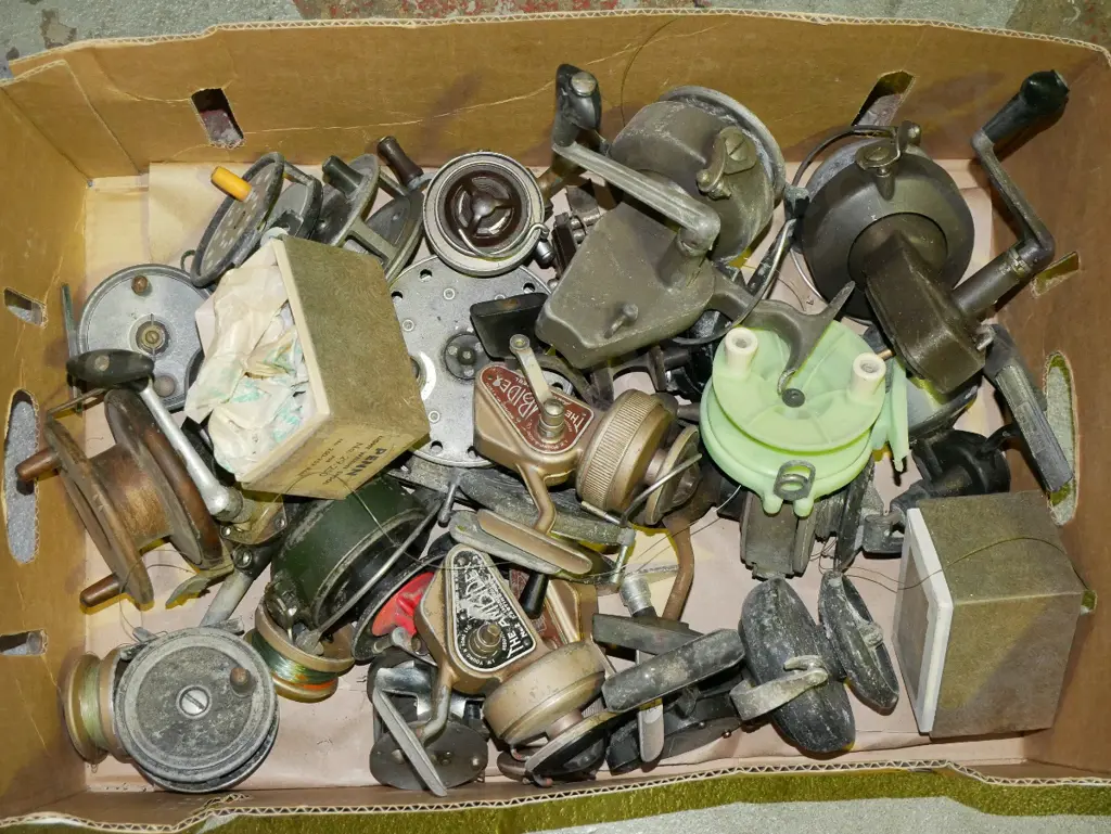 box of numerous vintage fishing reels Image 1++