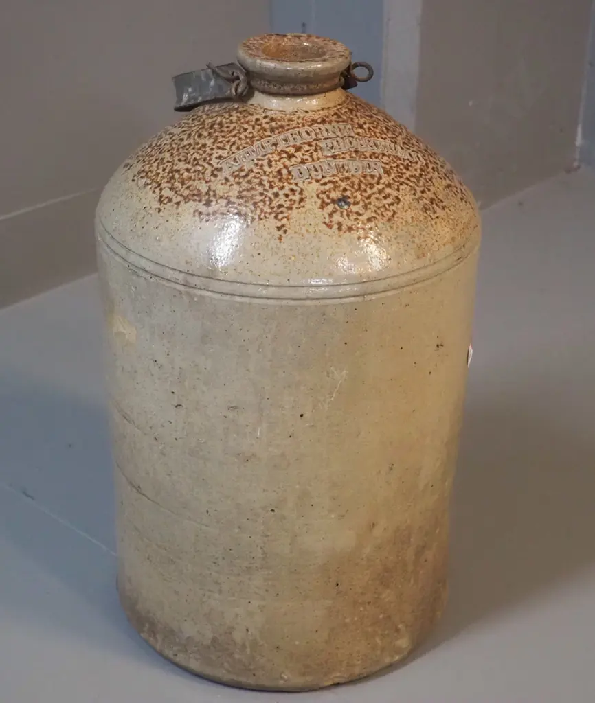 narrow-mouth stoneware crock with metal handle - marked Kempthorne Prosser Dunedin - small chip to mouth H-370 D-210 Image 1++