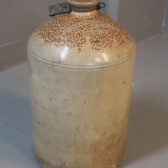 narrow-mouth stoneware crock with metal handle - marked Kempthorne Prosser Dunedin - small chip to mouth H-370 D-210