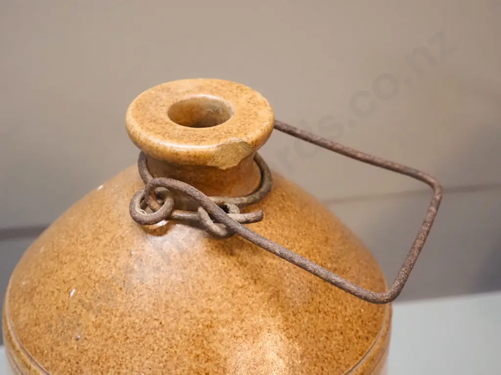 small narrow-mouth stoneware crock with wire handle - Cordials Limited Timaru - chip to mouth H310 D170 Image 1++