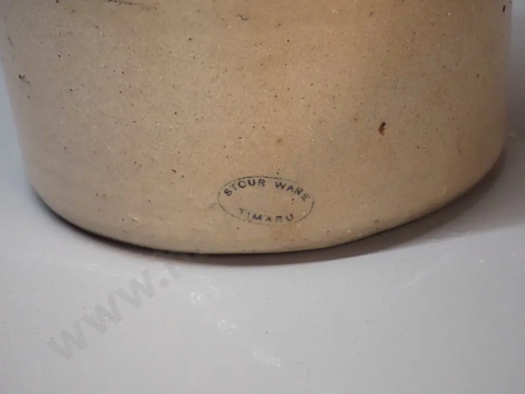 small narrow-mouth stoneware crock with wire handle - Cordials Limited Timaru - chip to mouth H310 D170 Image 1++