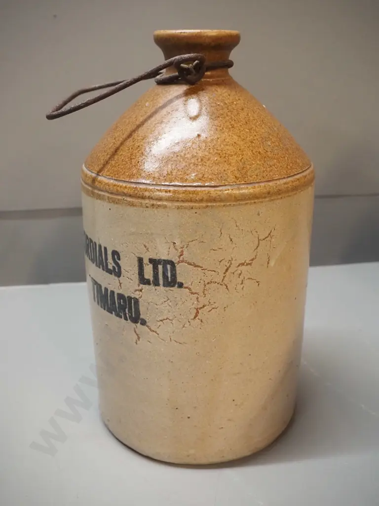 small narrow-mouth stoneware crock with wire handle - Cordials Limited Timaru - chip to mouth H310 D170 Image 1++