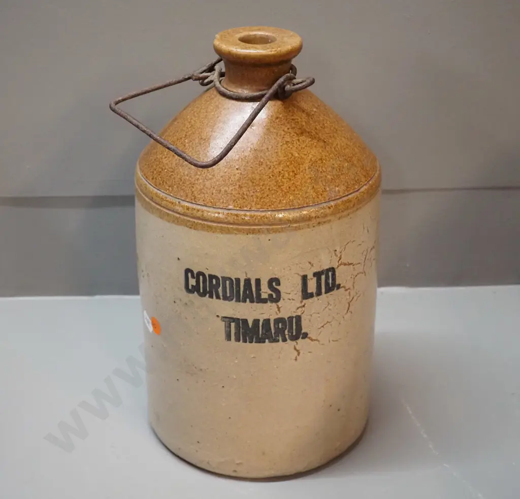 small narrow-mouth stoneware crock with wire handle - Cordials Limited Timaru - chip to mouth H310 D170 Image 1++