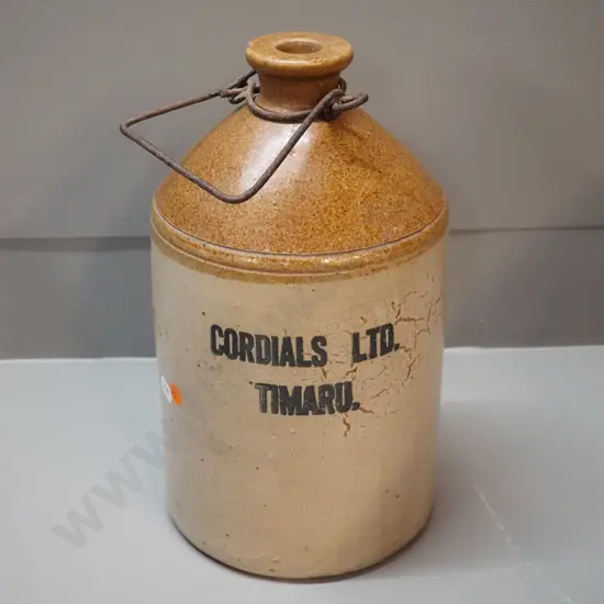 small narrow-mouth stoneware crock with wire handle - Cordials Limited Timaru - chip to mouth H310 D170