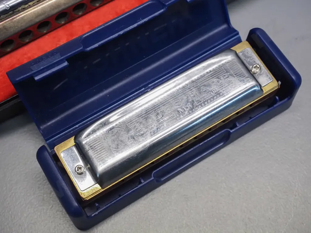 2 Hohner harmonicas in plastic cases - larger Larry Adler Professional 16 in C and a smaller Blues Harp MS in C Image 1++