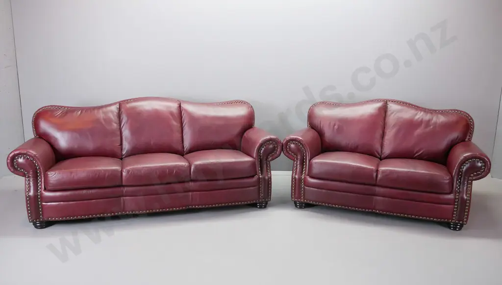 red leather hump backed rolled arm suite comprising a 3 and a 2 -seater Image 1++