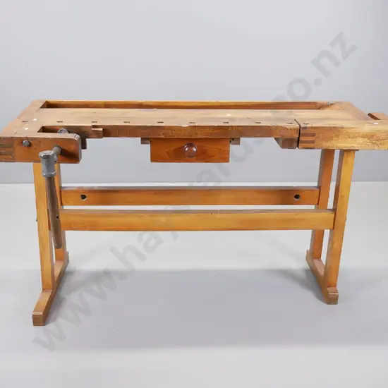 sloped top oak and elm continental workbench having wooden vice at either end on new refrectory base