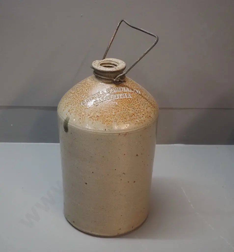 small narrow-mouth stoneware crock with wire handle - marked Clutha Cordial Co. Balclutha, small chip to mouth H320 D180 Image 1++