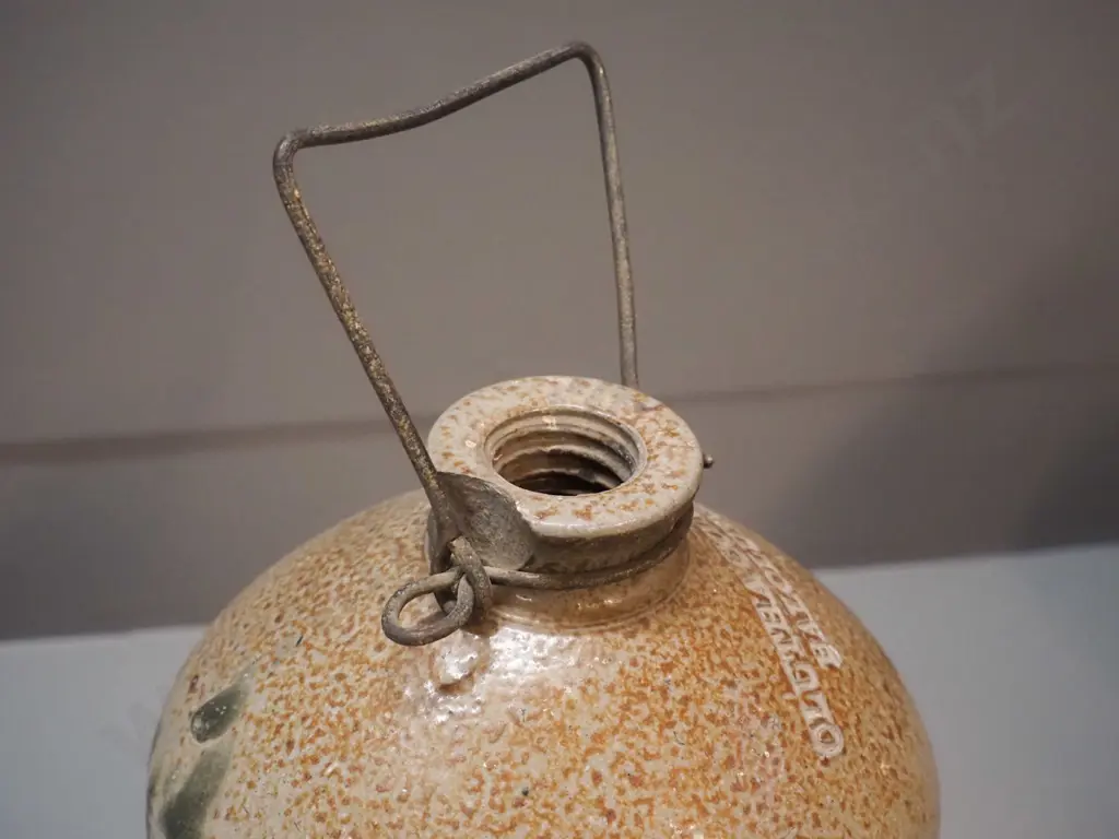 small narrow-mouth stoneware crock with wire handle - marked Clutha Cordial Co. Balclutha, small chip to mouth H320 D180 Image 1++