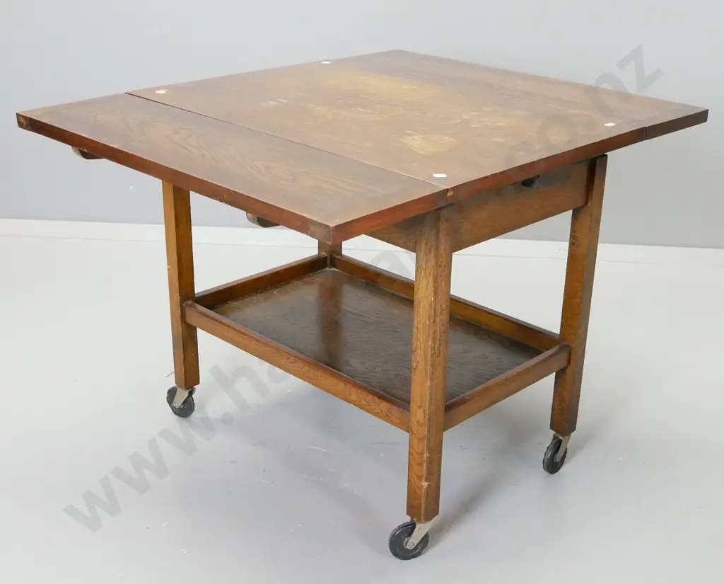 oak draw-leaf 2-tier tea trolley on black plastic casters - wear / staining to top centre section. H-640 L-730 W-890 ext Image 1++