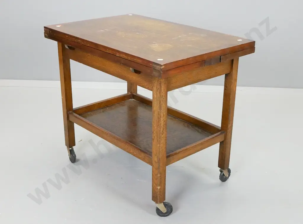 oak draw-leaf 2-tier tea trolley on black plastic casters - wear / staining to top centre section. H-640 L-730 W-890 ext Image 1++