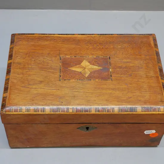 early timber box with inlaid banding and centre motif, brass escutcheon, lining damaged and original tray missing H-110