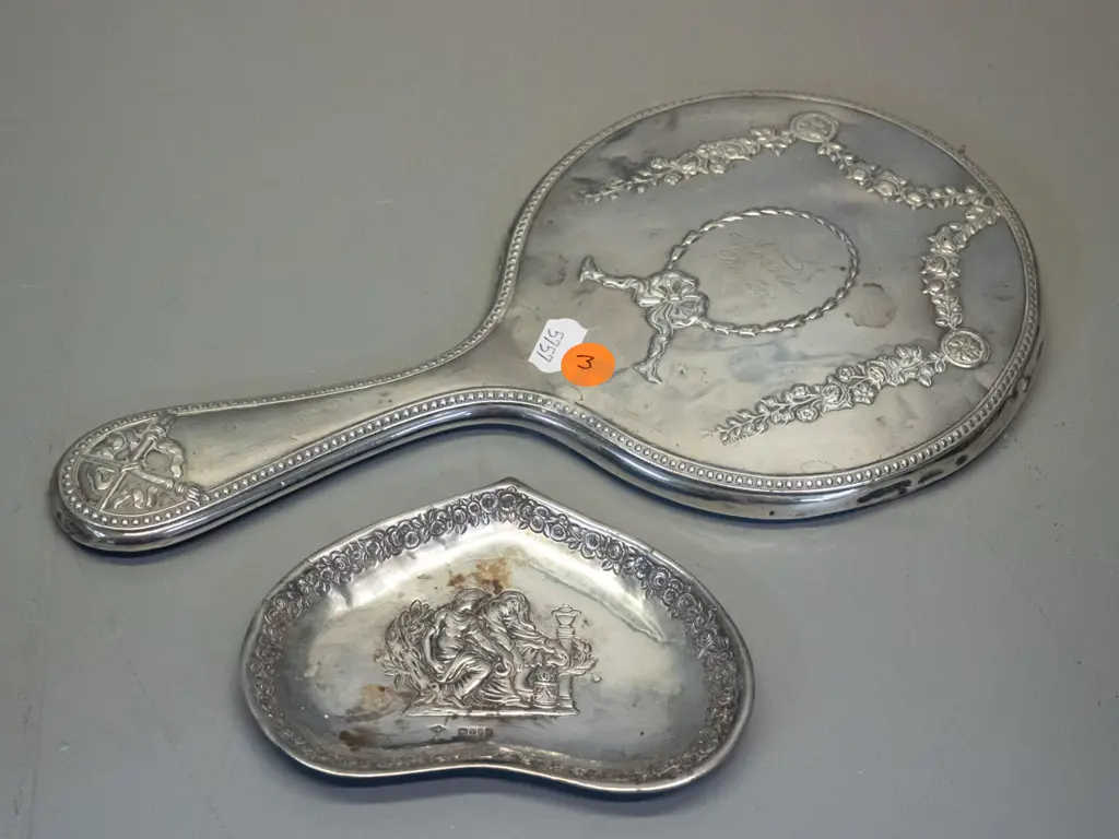 sterling silver dressing table hand mirror w/1912 inscription, and a small dish with embossed figural design Image 1++