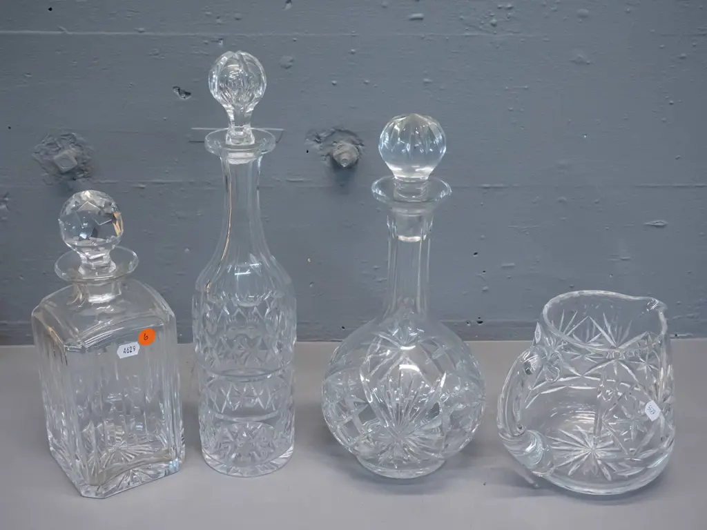 4 pieces cut crystal - 3 stoppered decanters and a water jug. Tallest decanter H-350, one stopper has chip to base Image 1++