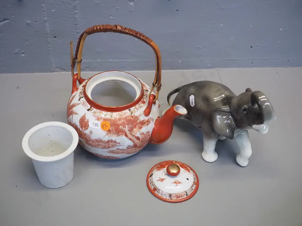 asian Kutani style teapot with strainer and cane handle, small chips to rim, and a porcelain elephant figurine H170 L200 Image 1++