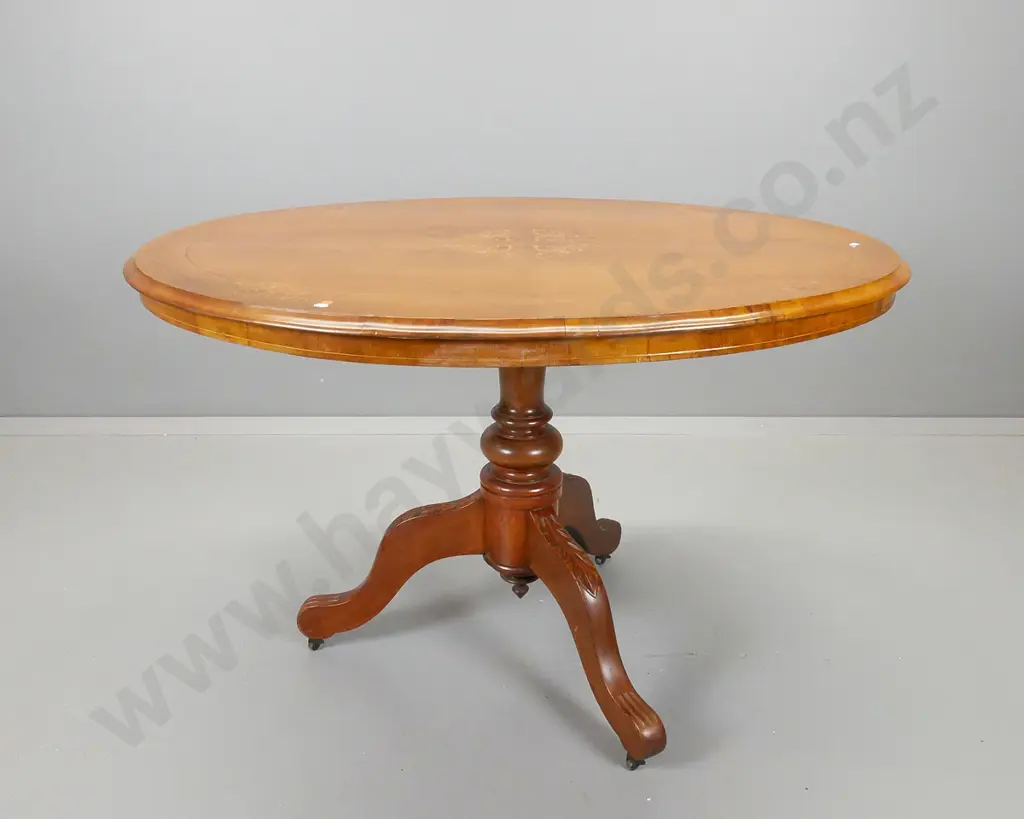 oval walnut loo table with boxwood inlays on tilting top mechanism, pedestal base with three scrolling legs Image 1++