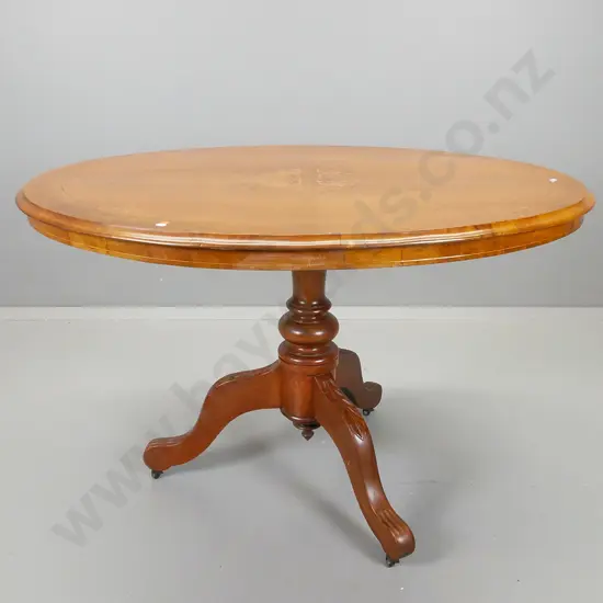 oval walnut loo table with boxwood inlays on tilting top mechanism, pedestal base with three scrolling legs