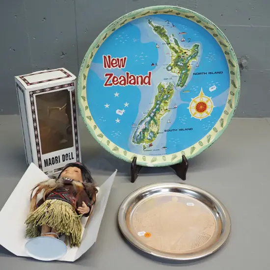New Zealand souvenir ware - 2 trays and a Maori doll in original packaging. Scratches and wear to trays, larger is D390