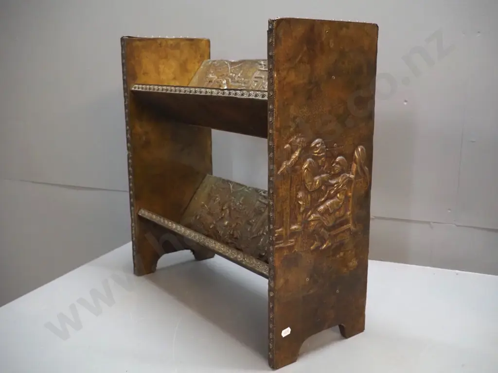 2-tier timber open-back bookcase with angled shelves, all covered in beaten brass with various figural scenes H420 W490 Image 1++