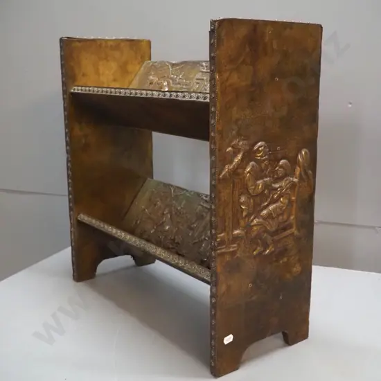 2-tier timber open-back bookcase with angled shelves, all covered in beaten brass with various figural scenes H420 W490