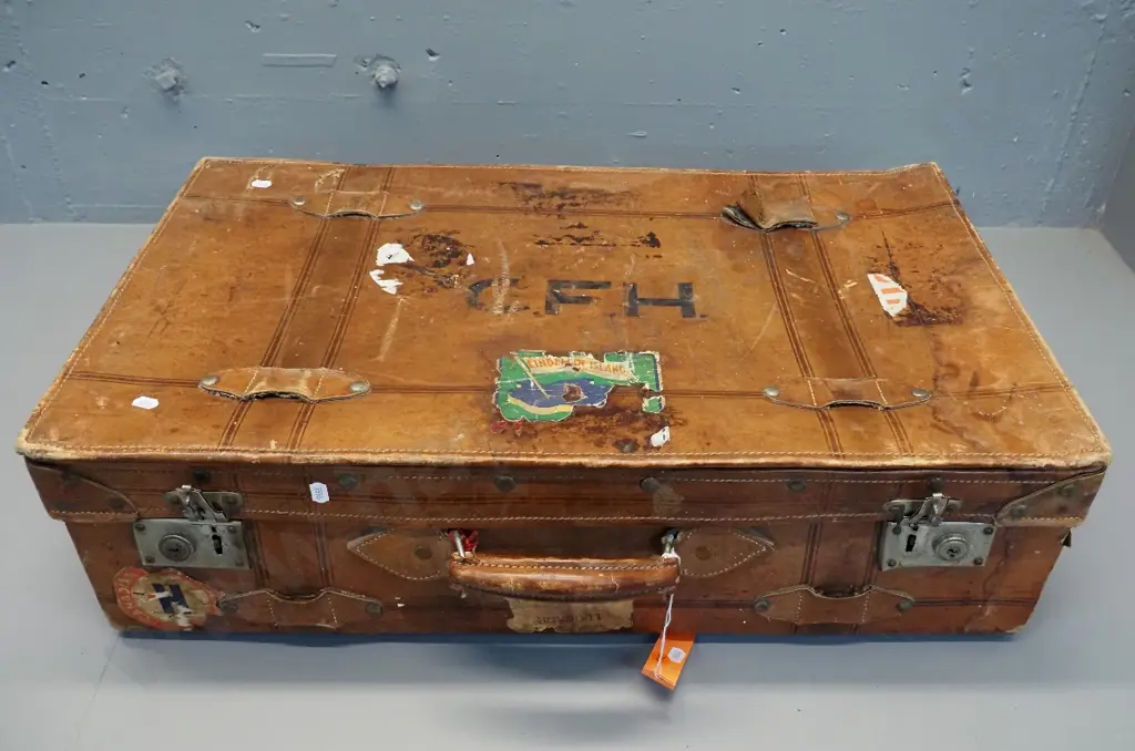 vintage leather suitcase with brass studding, travel label fragments, label inside: made by Pikah Leather Products Hong Image 1++