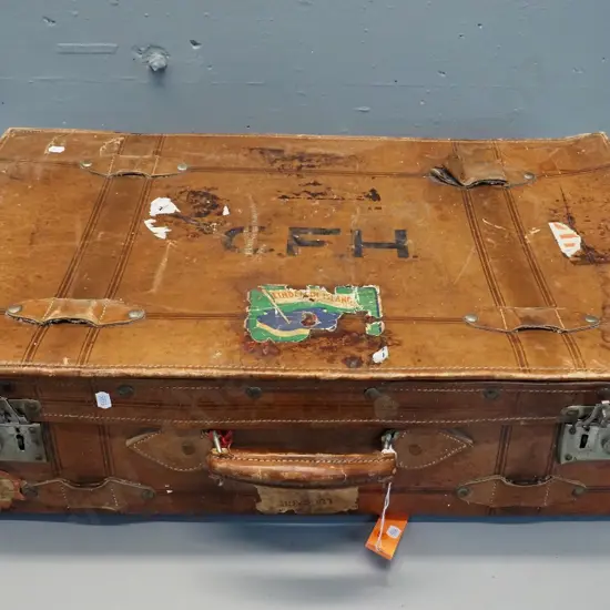 vintage leather suitcase with brass studding, travel label fragments, label inside: made by Pikah Leather Products Hong