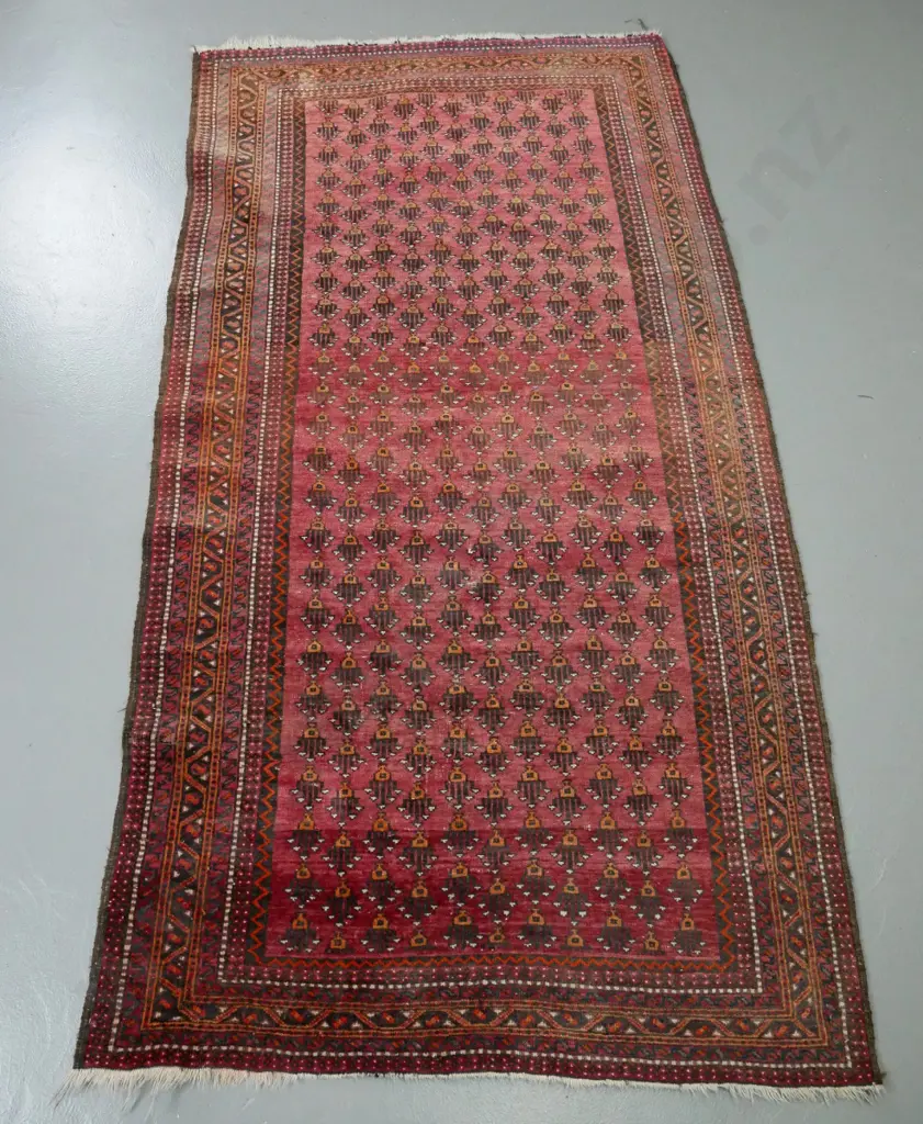 hand-knotted wool floor rug - red ground, orange and browns, geometric patterns - some fading and wear L-1950 W-1040 Image 1++