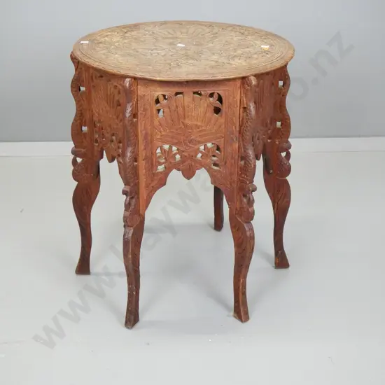 Indian hardwood heavily carved 6-legged occasional table with bird and foliage decoration - worn finish on top, chips to