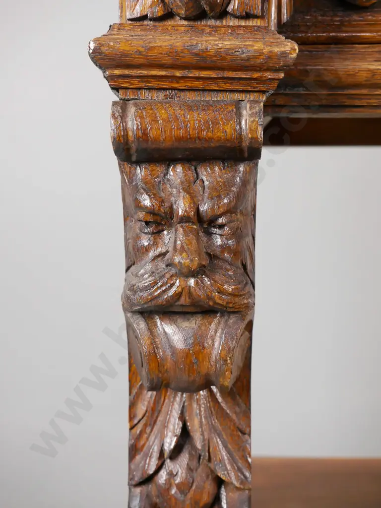 Victorian carved oak dumb waiter having foliate and floral carved crest back above a foliate carved drawer Image 1++