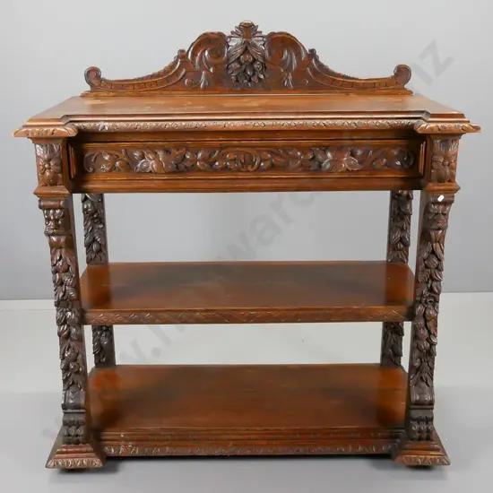 Victorian carved oak dumb waiter having foliate and floral carved crest back above a foliate carved drawer