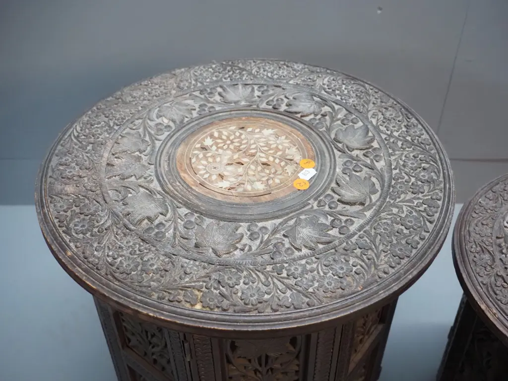 2 ornately carved Indian hardwood collapsible tables with bone inlay decoration, octagonal bases - larger one has damage Image 1++