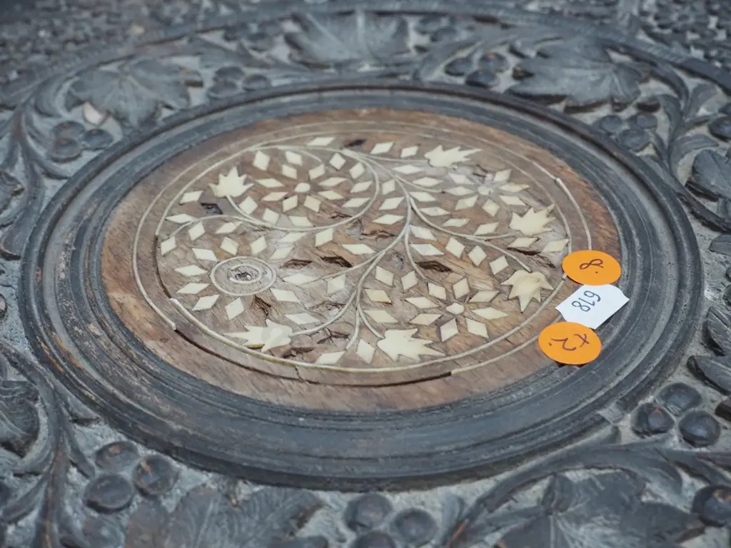 2 ornately carved Indian hardwood collapsible tables with bone inlay decoration, octagonal bases - larger one has damage Image 1++