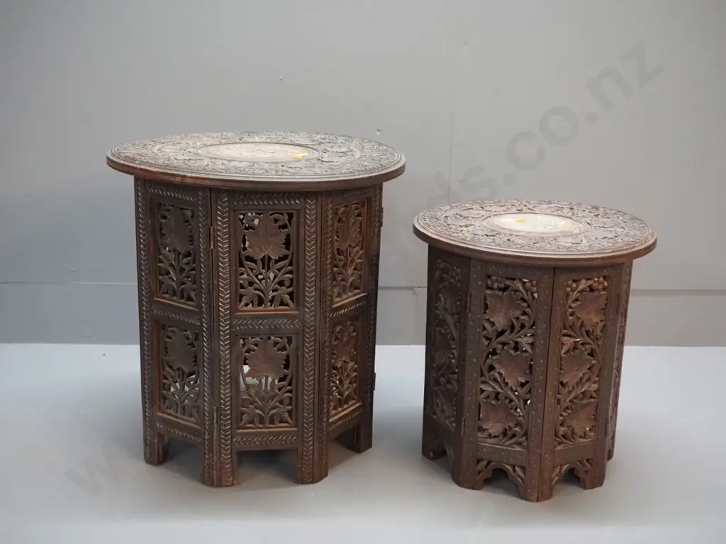 2 ornately carved Indian hardwood collapsible tables with bone inlay decoration, octagonal bases - larger one has damage Image 1++