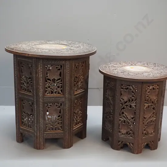 2 ornately carved Indian hardwood collapsible tables with bone inlay decoration, octagonal bases - larger one has damage