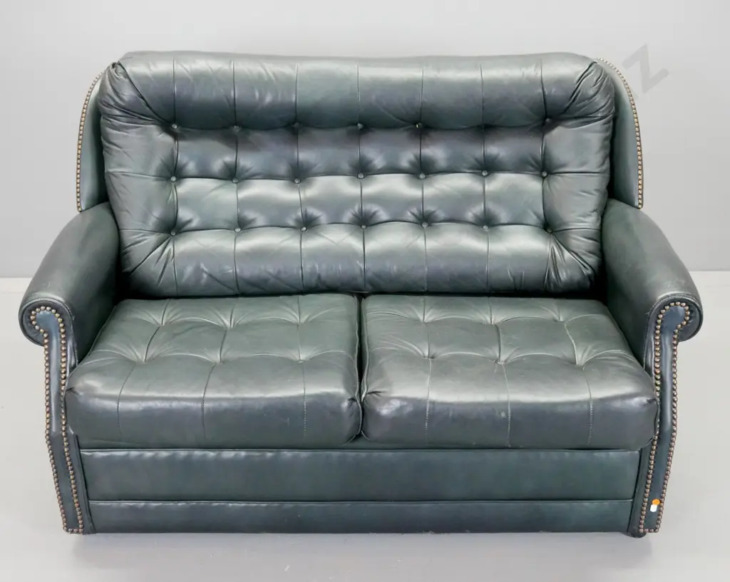 dark green leather upholstered deep button 2-seater settee with brass studded decoration, loose seat cushions, on Image 1++