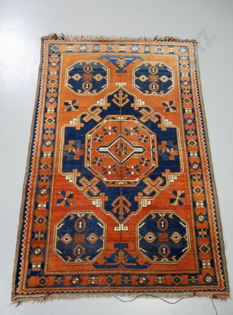 hand-knotted wool floor rug - brown, blue and cream - central geometric motif. Some wear, fading to one end L-1360 W-880 Image 1++