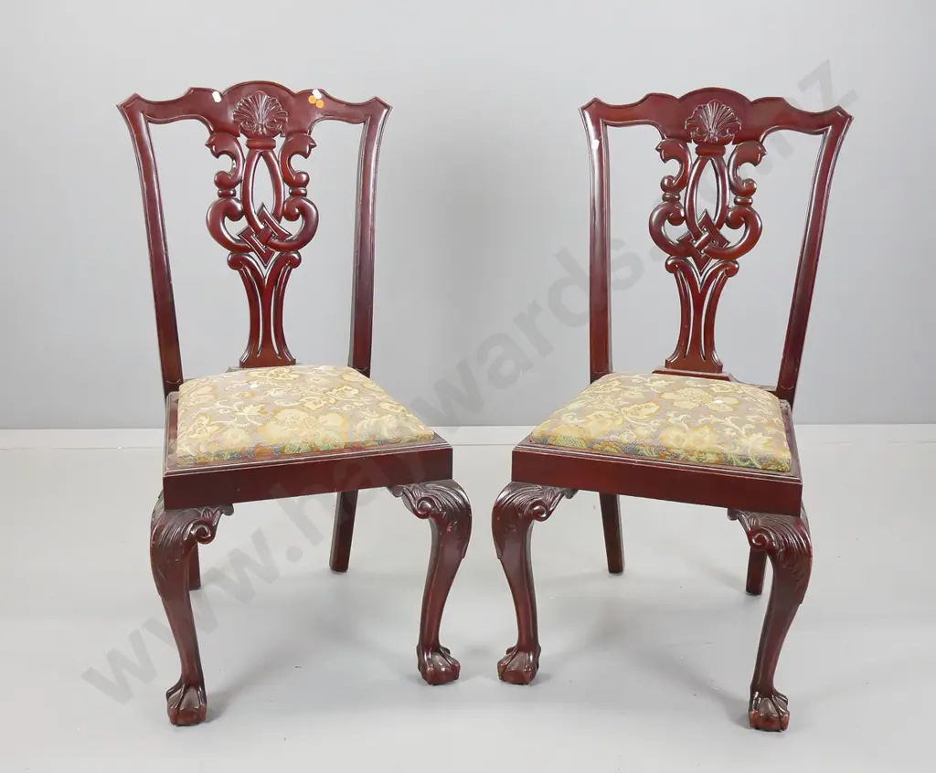 pair of reproduction Chippendale style mahogany chairs with pierced backsplat on foliate scrolling legs Image 1++