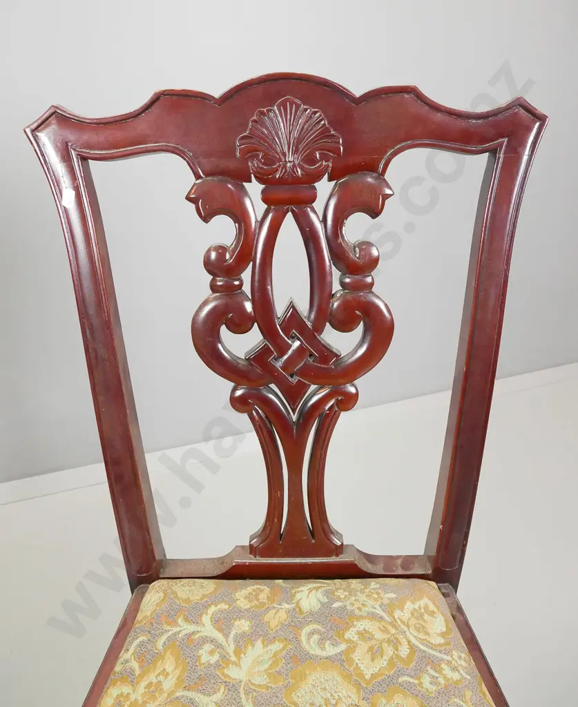 pair of reproduction Chippendale style mahogany chairs with pierced backsplat on foliate scrolling legs Image 1++