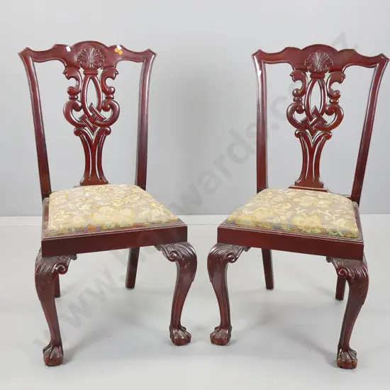 pair of reproduction Chippendale style mahogany chairs with pierced backsplat on foliate scrolling legs